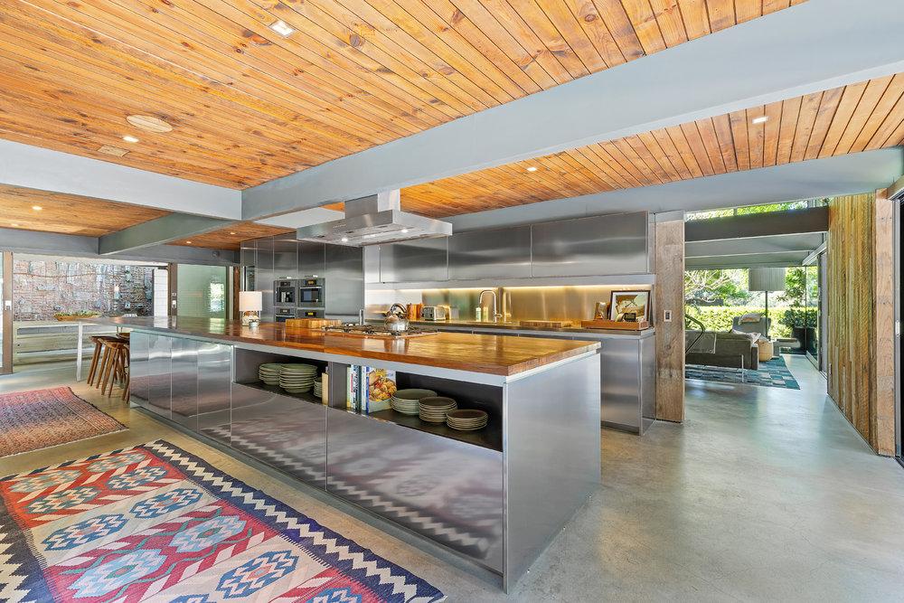 A state-of-the-art kitchen comes with a 24-foot long stainless steel and walnut island