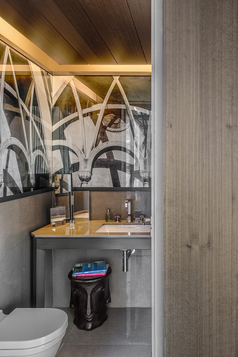A sculptural side table-stool sits in one of the bathrooms. (Photo: Alex Jeffries)