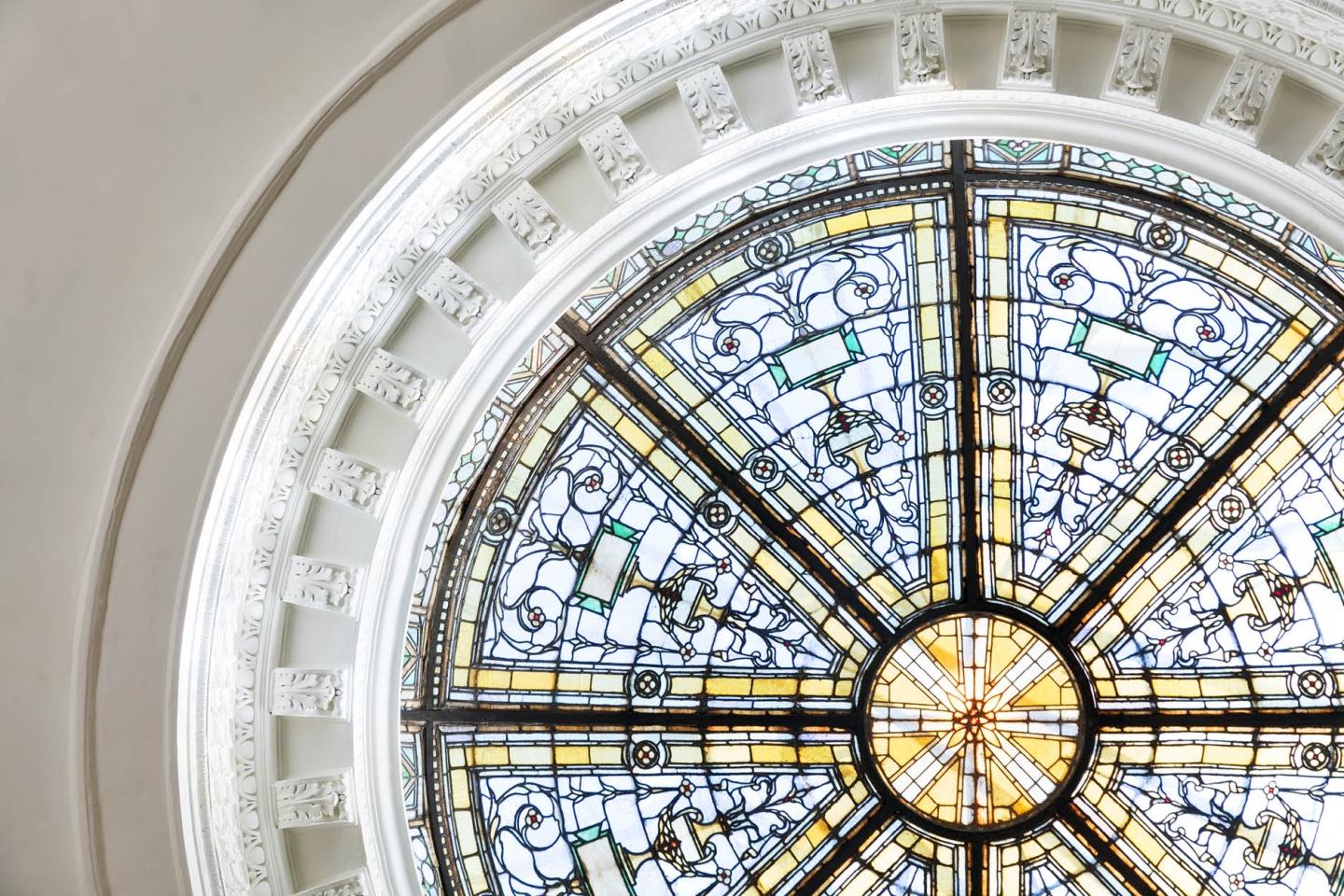 The stained glass domed ceiling