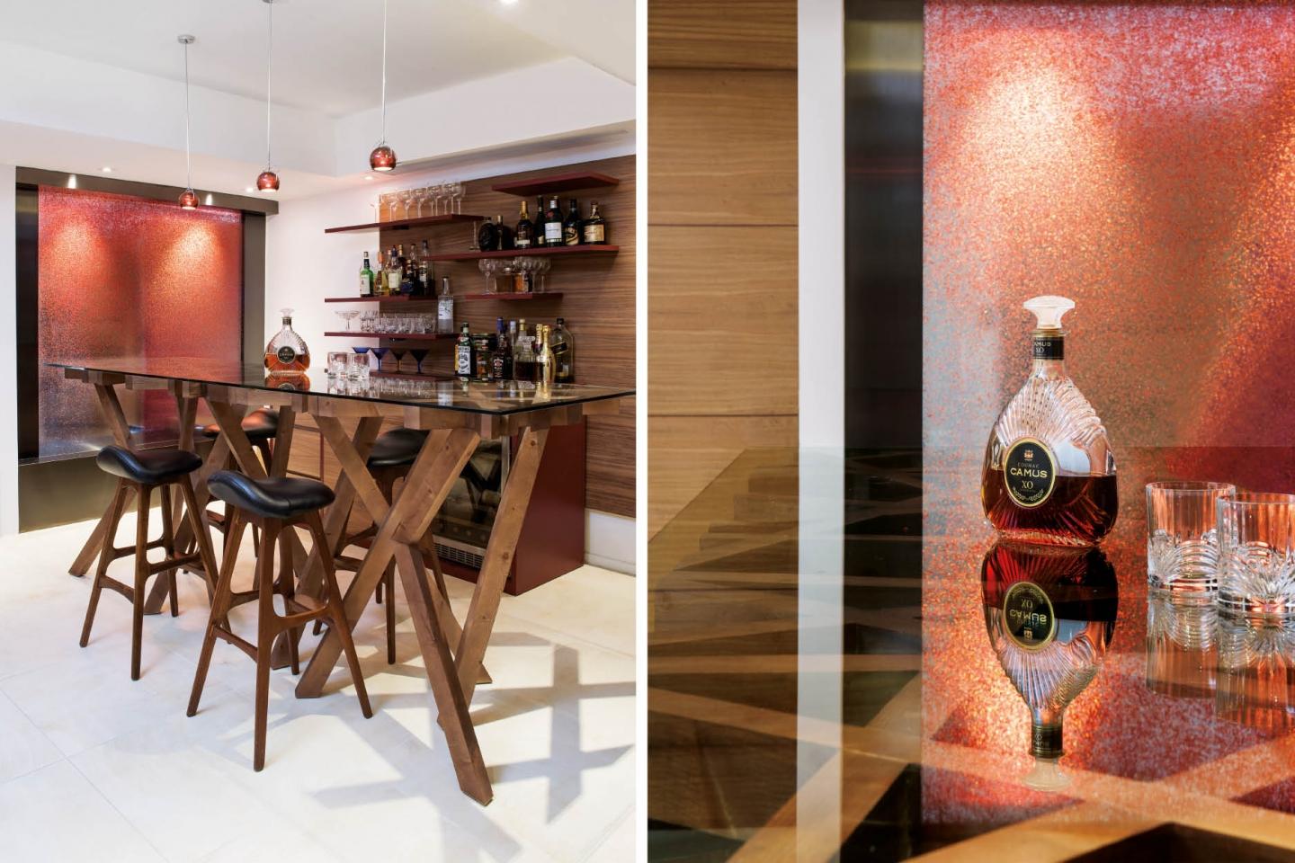 Shades of red and dark wood detailing endow the bar with the ambience of a contemporary gentleman's club