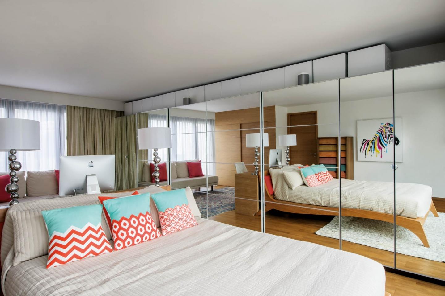 Mirrored storage gives the illusion of extra space and adds light to the guest bedroom