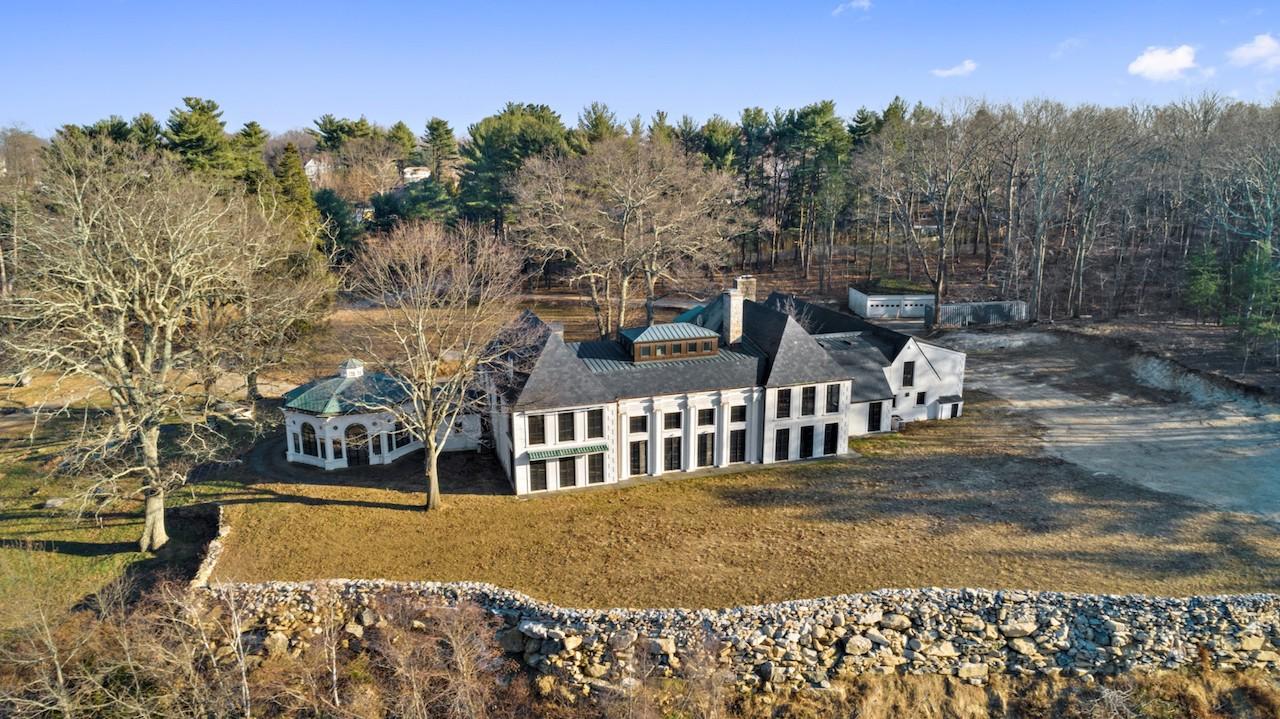 A 13,000-square-foot main house is surrounded by numerous guest houses and amenities