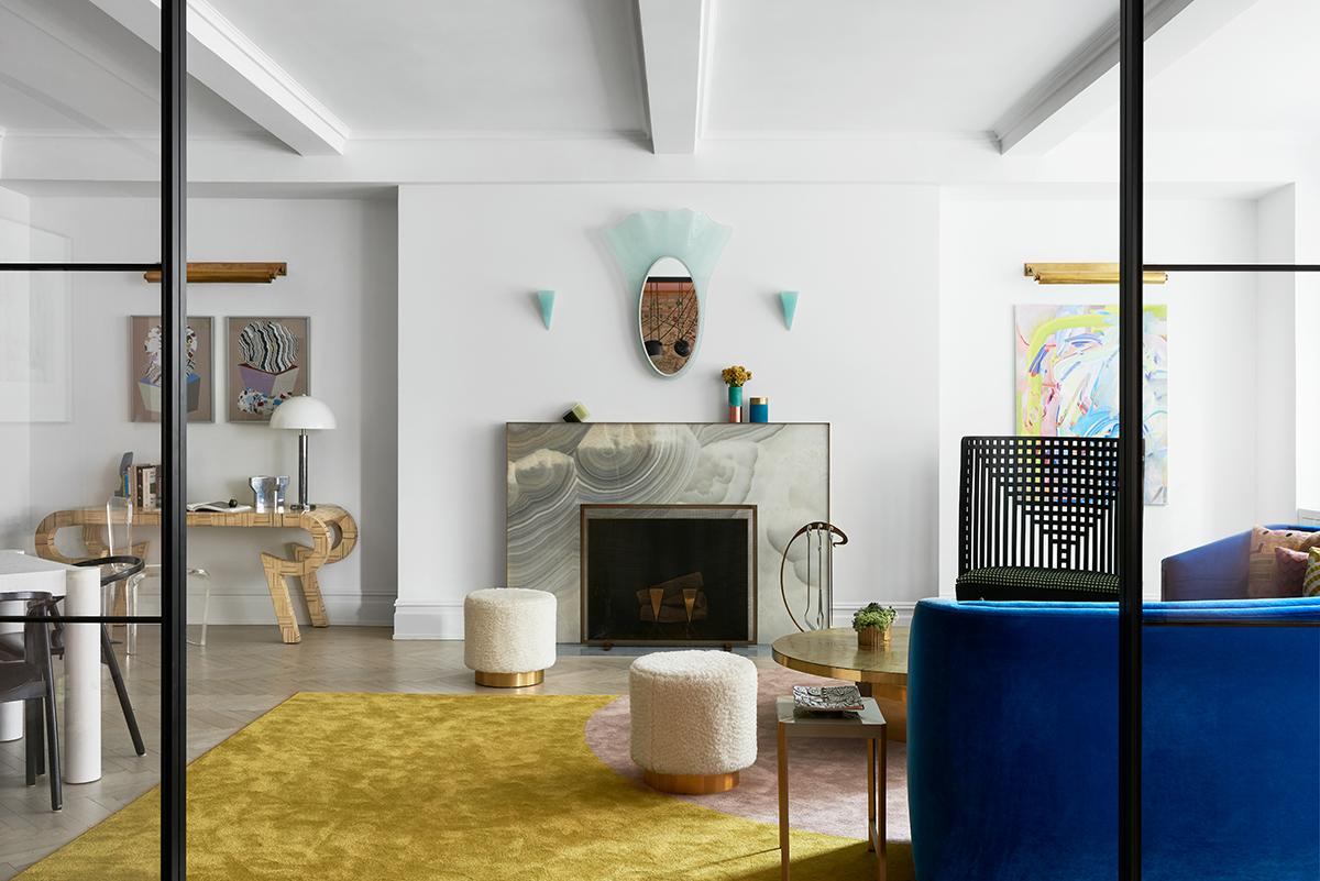 A new grey onyx and bronze fireplace mantel was installed, flanked by turquoise glass sconces. Above, a vintage Fontana Arte mirror. (Photo: Brooke Holm)