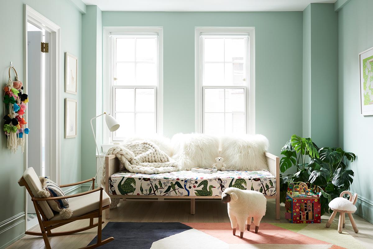 In the daughter's bedroom, sheepskin pillows sit on a CB2 daybed with a custom cushion, upholstered in a botanical print by Josef Frank. (Photo: Brooke Holm)