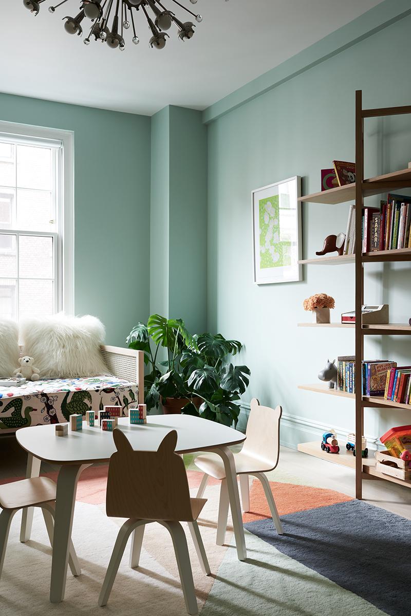 The tall shelving is from Hem; the animal footstool pieces are from Kinder Modern. (Photo: Brooke Holm)
