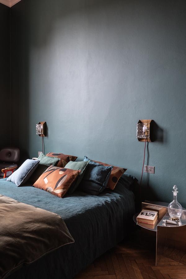 The bedroom gives a muted, earthy colour palette