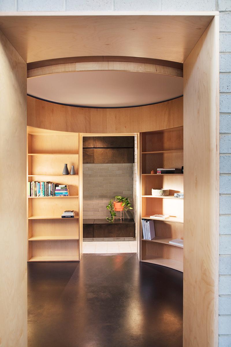 The circular library serves as the first stop for anyone entering the home, and features personal belongings and items connected to the homeowner's life in the city. (Photo: Bo Wong)