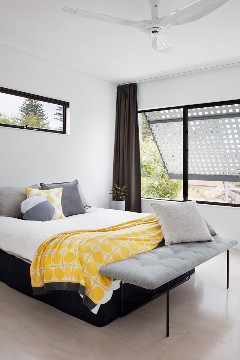 In the upstairs bedroom, a view of the operable lattice at the top of the home, which allows for privacy as well as sun protection while providing glimpses of the outside. (Photo: Bo Wong)
