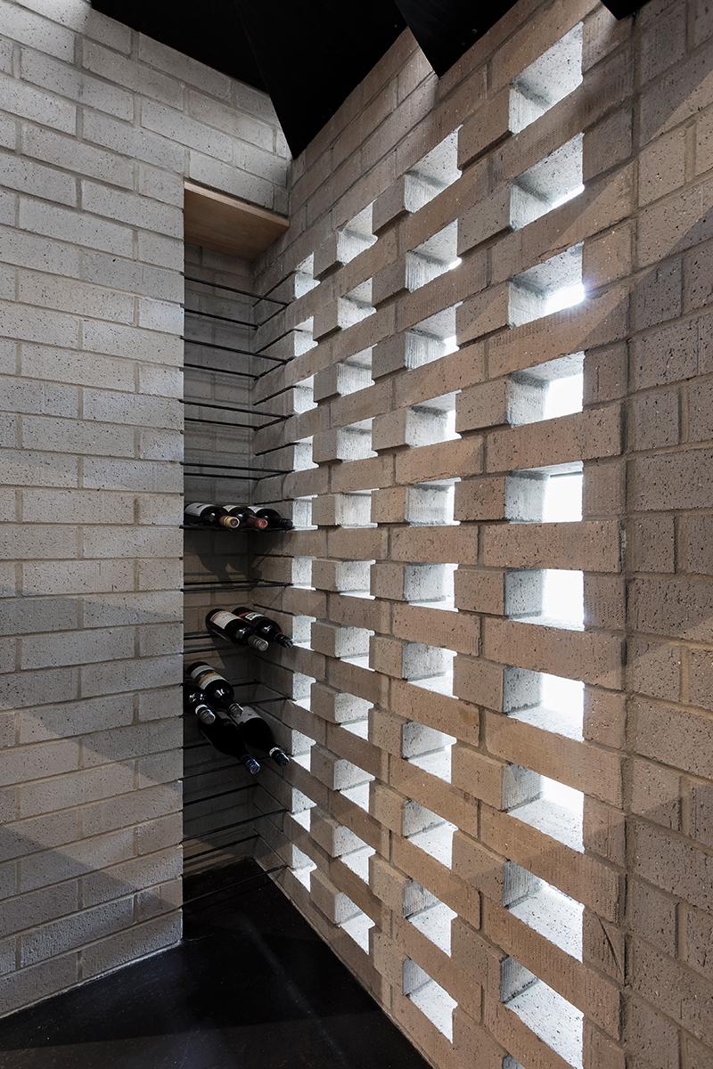 A mini wine cellar tucked behind brickwork. (Photo: Bo Wong)