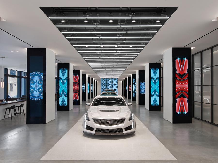 Cadillac models are displayed along a runway, which can also be used for events such as fashion shows