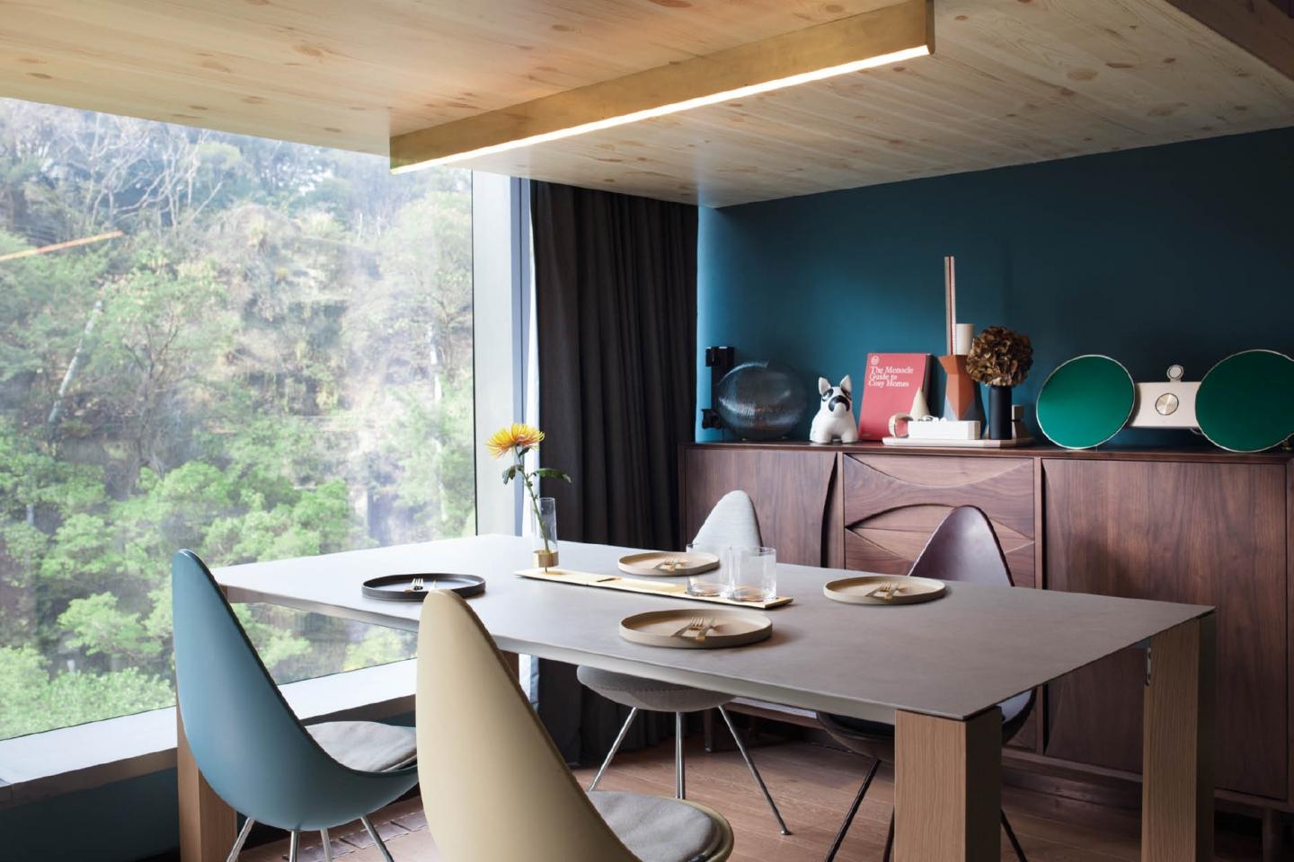 設計師為配合屋主的風格個性 而選用了這種灰藍色澤作全屋 背景主色。咖啡桌黃銅底座來 自Jottergoods，於Archetypal有售。餐桌佈置包括Klondike的日式陶瓷用具和Cutipol的餐具