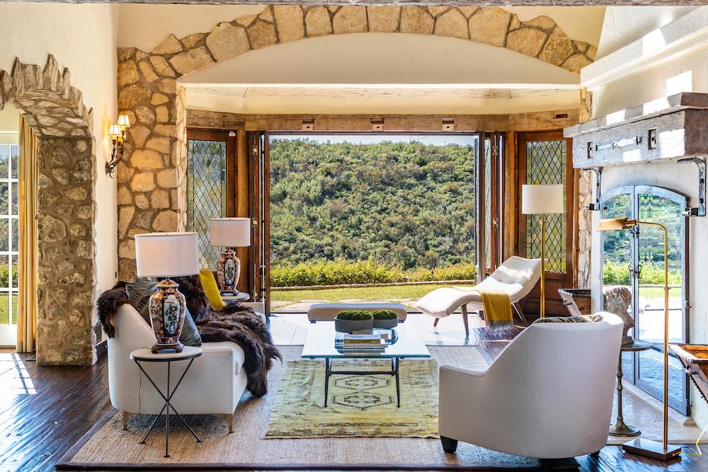French doors open up to a lush mountainous landscape