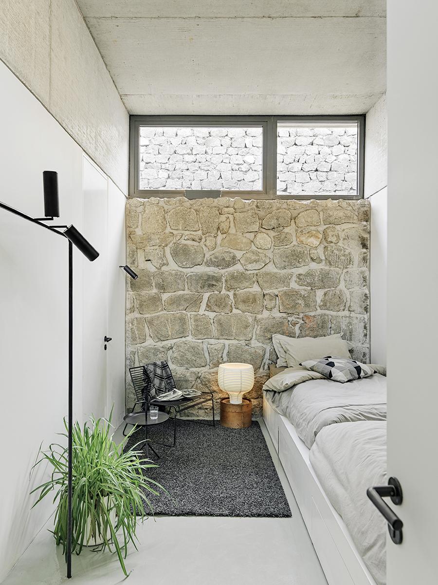 As in the living area, a minimalist aesthetic features in the bedrooms, with the pared-back white contrasting against the characterful stone walls. (Photo: Jonathan Leijonhufvud, courtesy of MDDM Studio)