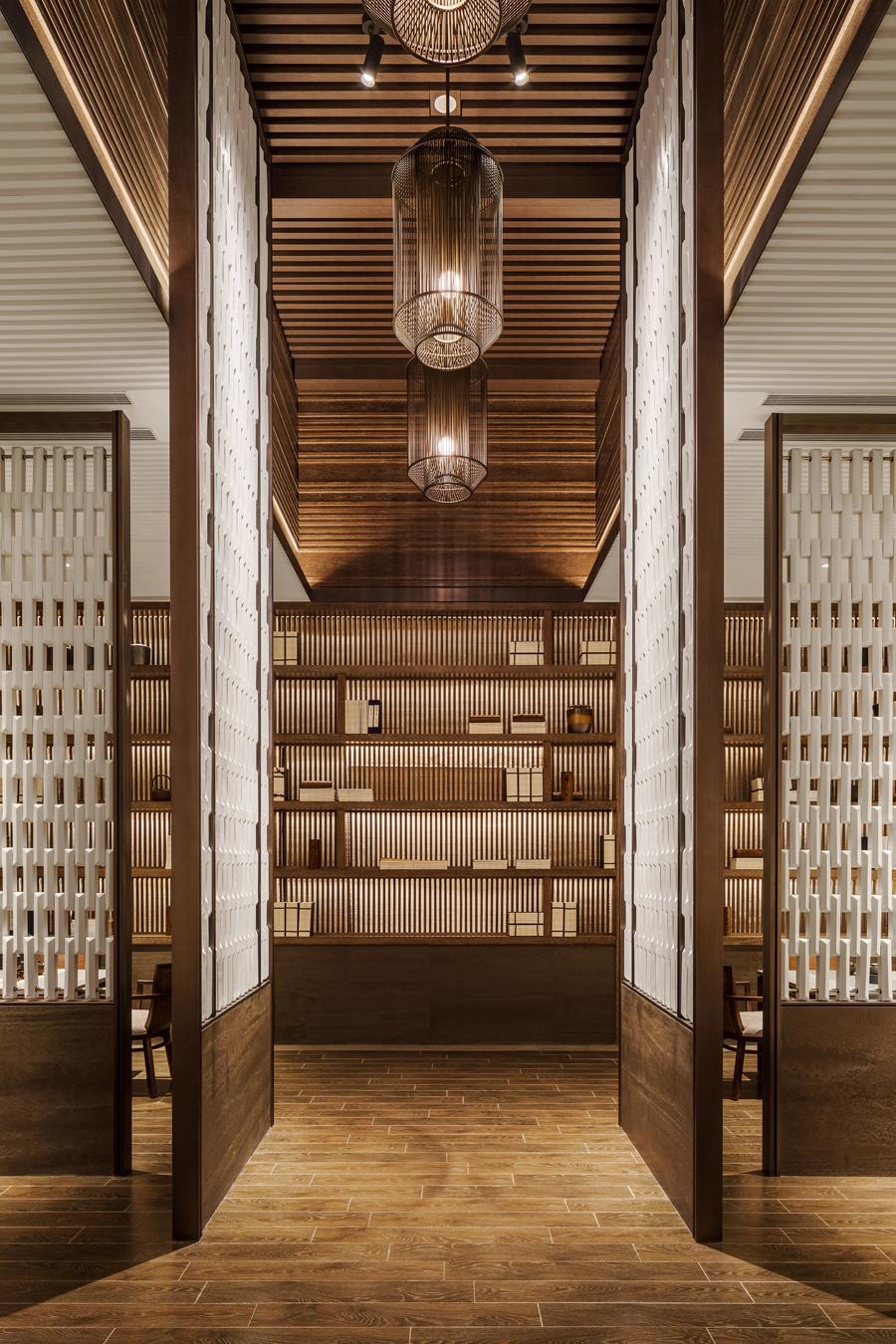 The Tea Library complete with wooden shelves displaying tea sets and books; guests can experience local tea culture guided by an expert tea master