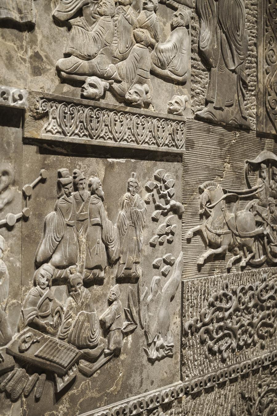 A meticulously crafted wall boasts scenes of old-world China