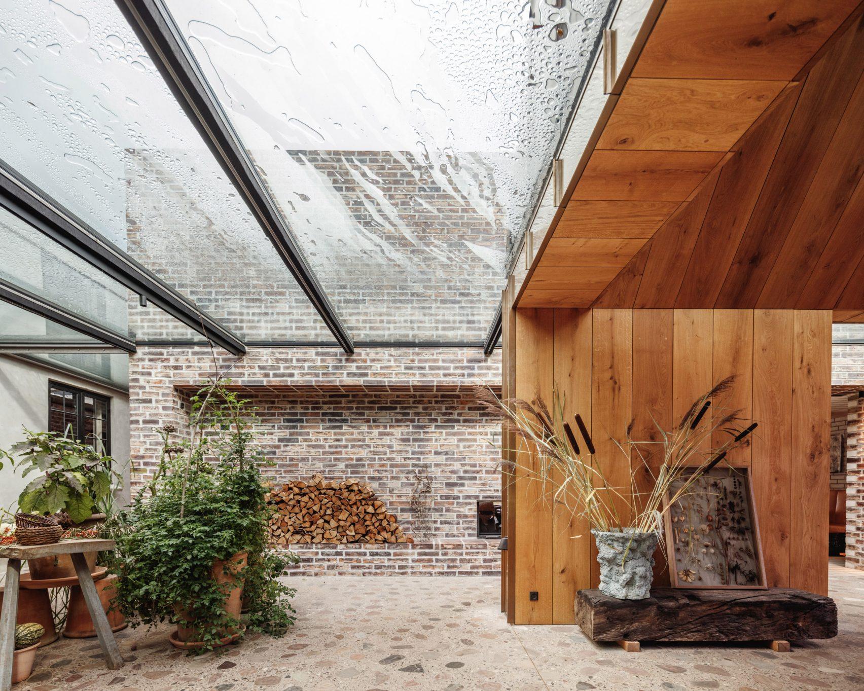 Sunlight streams through the glass roof into the brick and wood-decked interiors