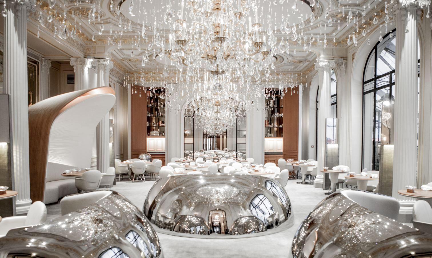 Gigantic glossy steel domes, solid oak tables and a striking chandelier take centre stage in the dining hall