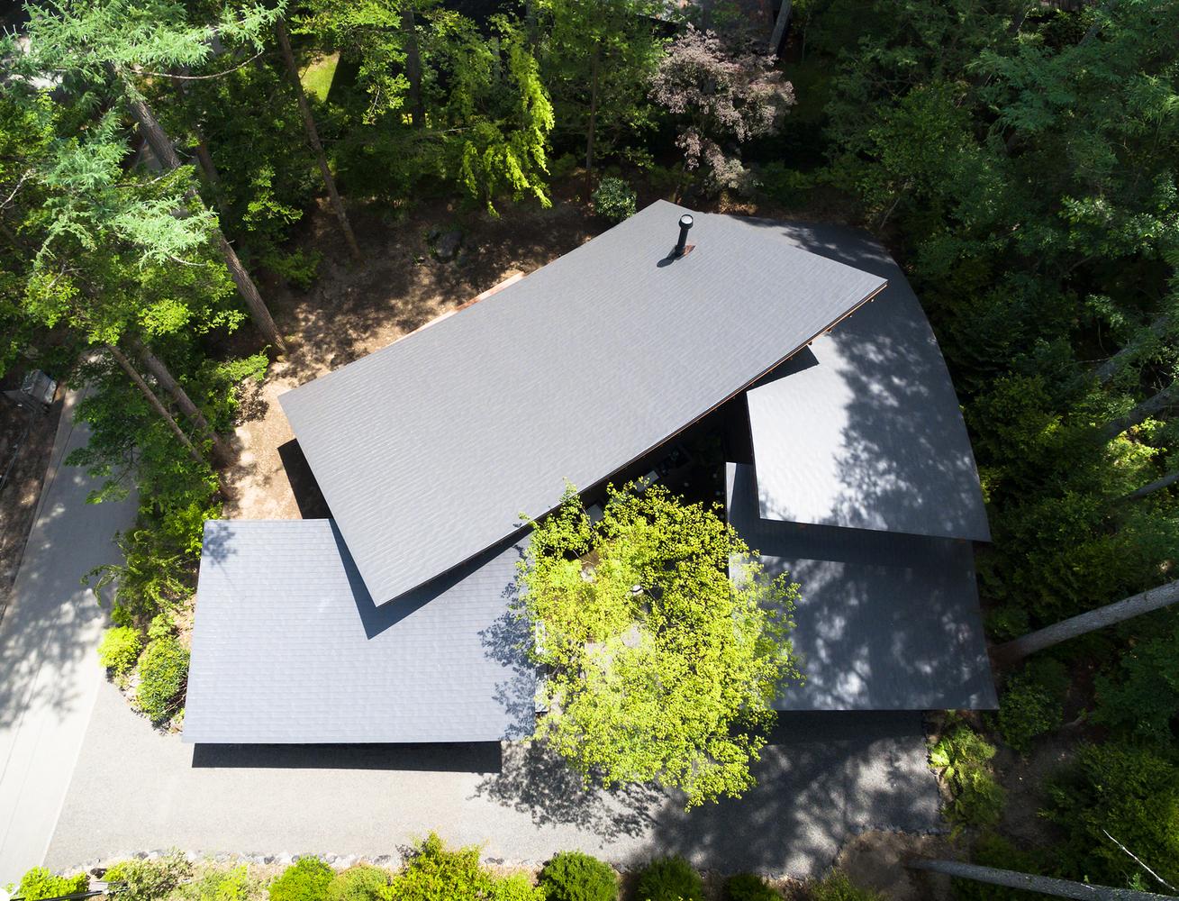 A Curvaceously-Roofed Villa in Karuizawa Melds Into The Landscape