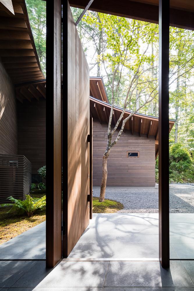 A Curvaceously-Roofed Villa in Karuizawa Melds Into The Landscape