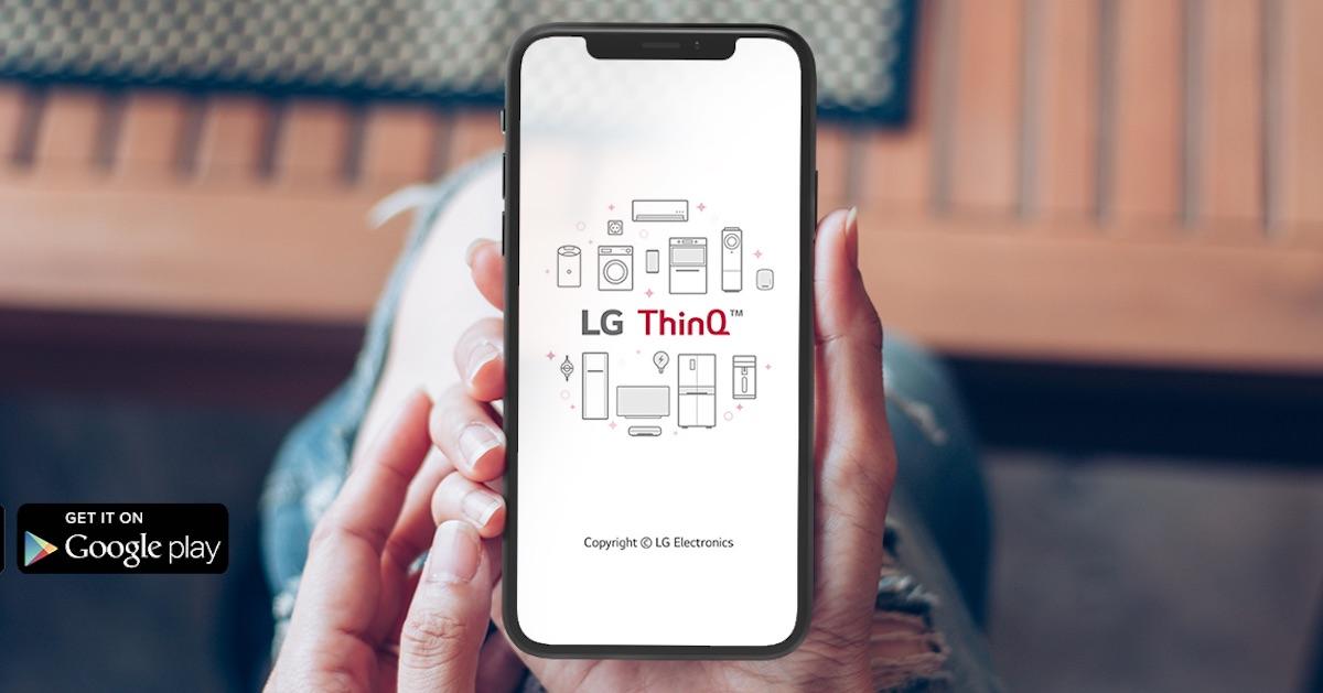  A hand holding a smartphone with the LG ThinQ app on the screen, which is used to control LG air conditioners and other LG appliances.