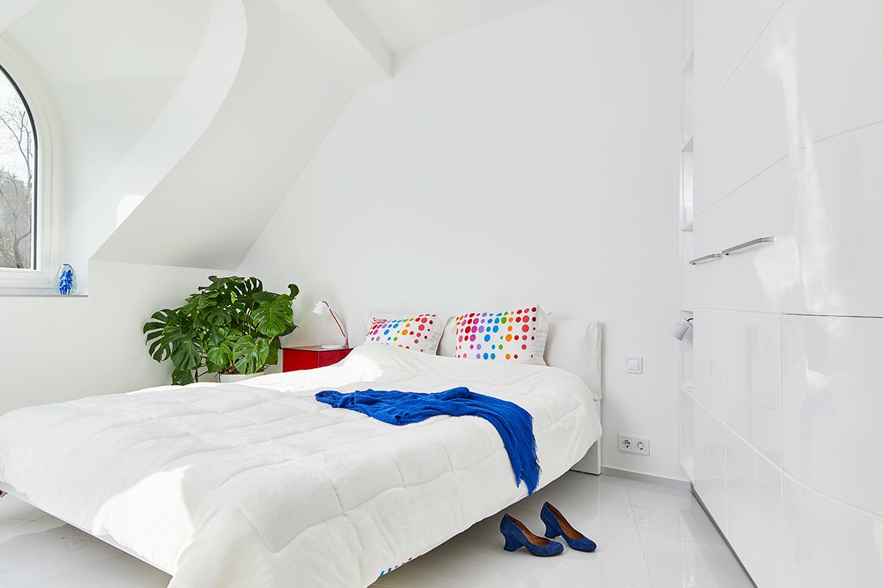 This All-White, 1,180sqft Apartment in Budapest is Splashed with Pops of Primary Colours