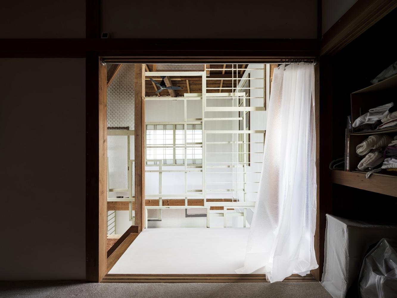 This two-storey house in Japan is decorated with old door frames 