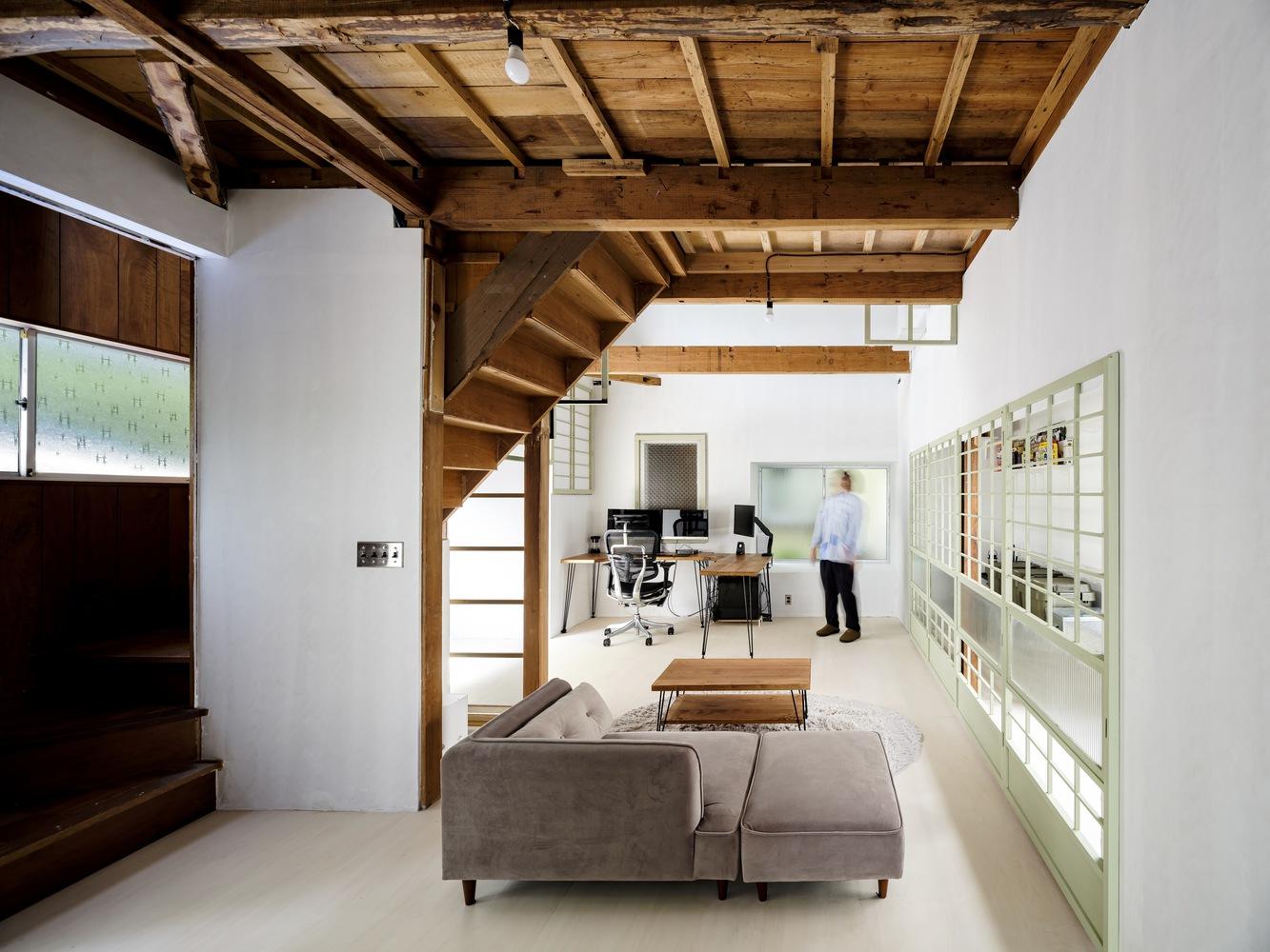 This two-storey house in Japan is decorated with old door frames 