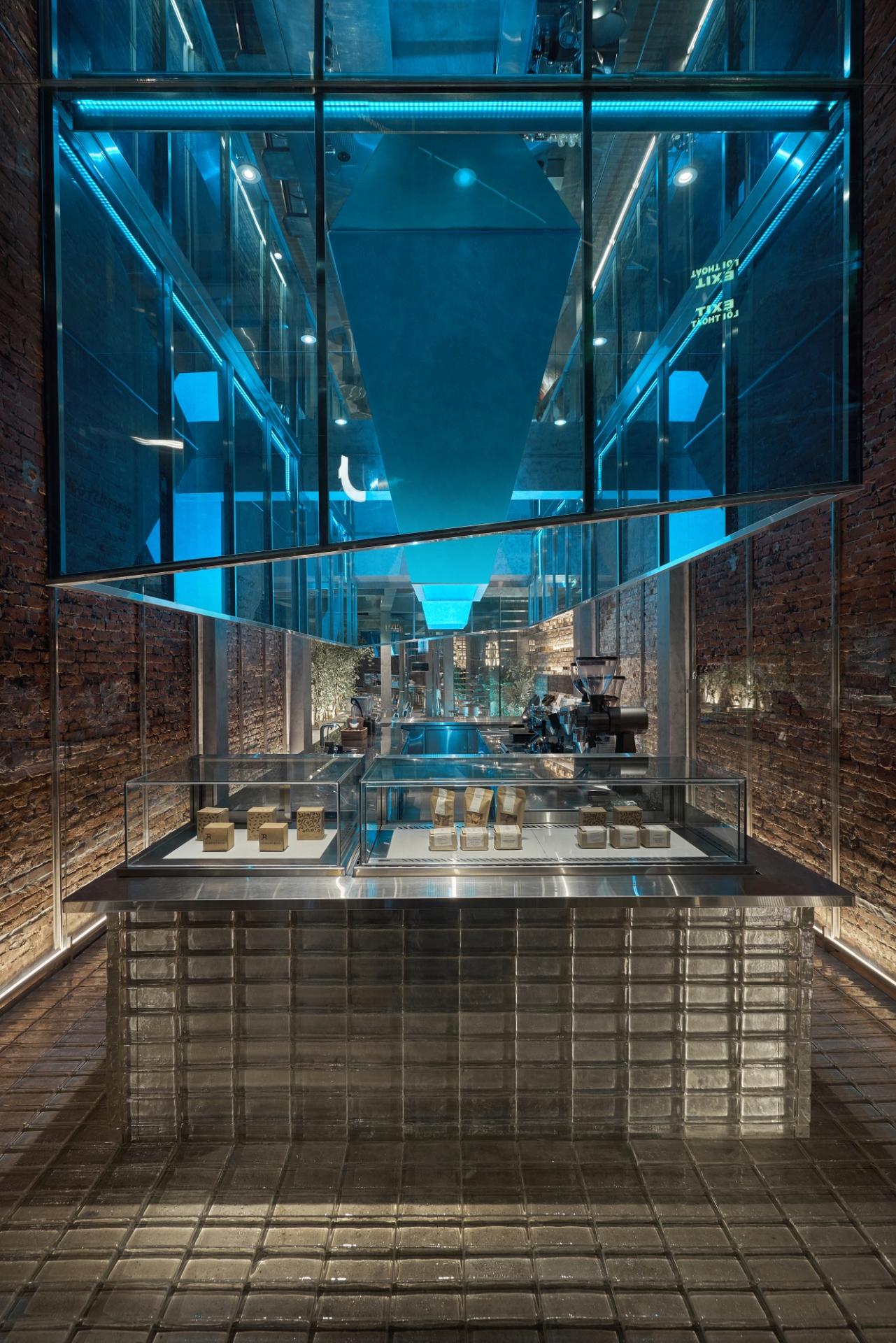 A+H architects wraps vietnam café with large, rotating glass doors