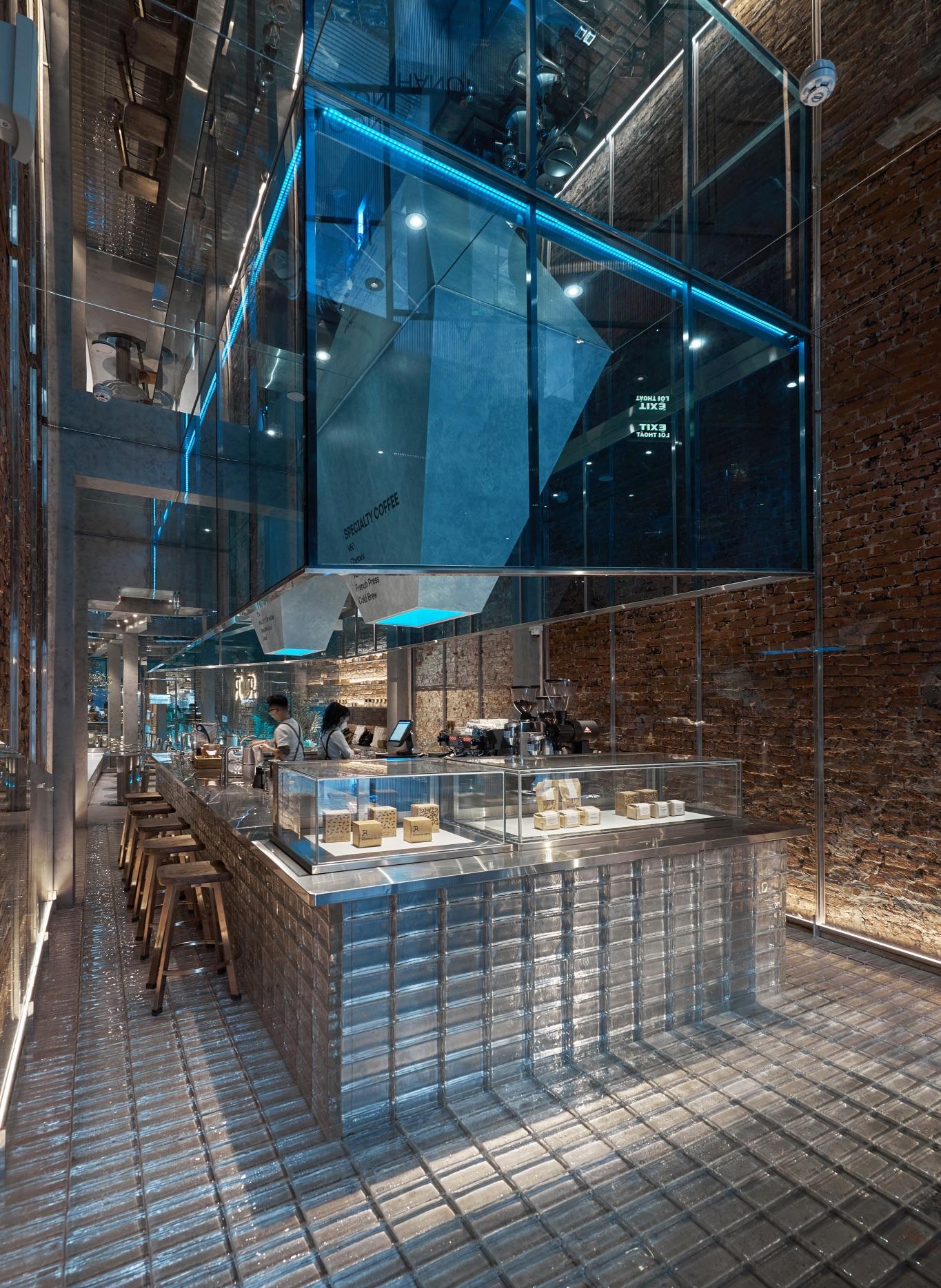 A+H architects wraps vietnam café with large, rotating glass doors